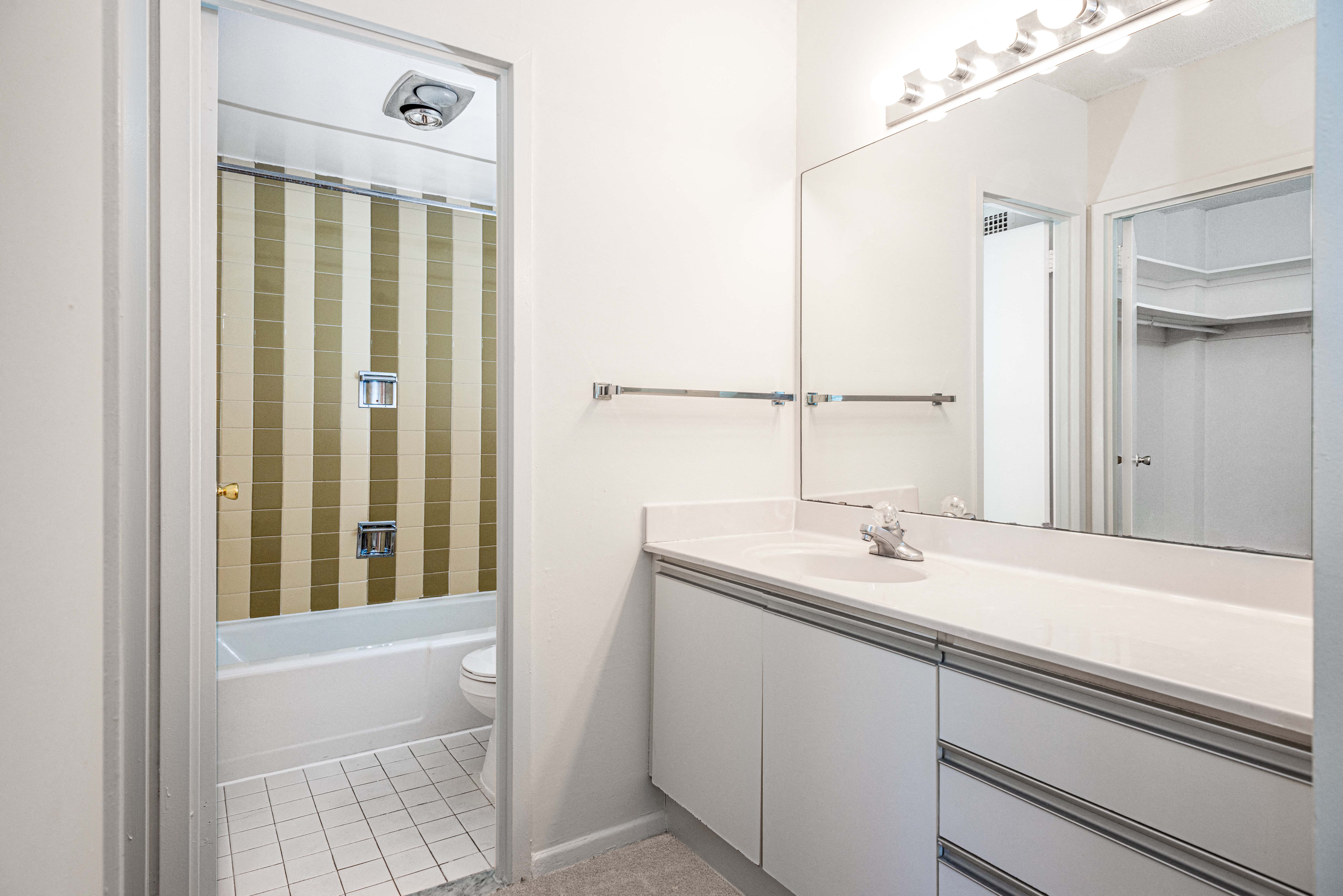 Bathrooms with separate vanity space and built-in lighting